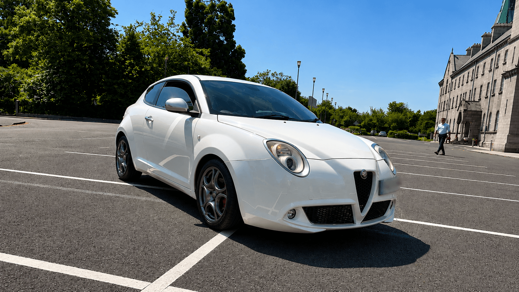 White Alfa Romeo MiTo parked in a sunny car park