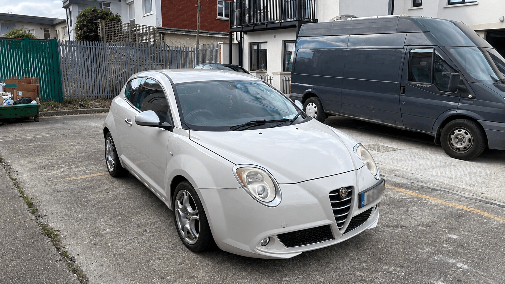 White Alfa Romeo MiTo parked outside a workshop